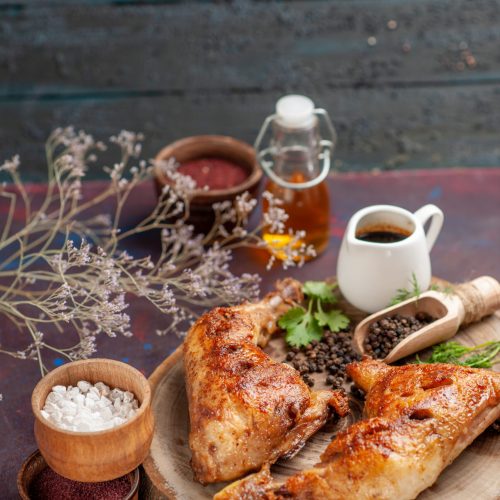 front-view-delicious-fried-chicken-with-different-seasonings-dark-desk